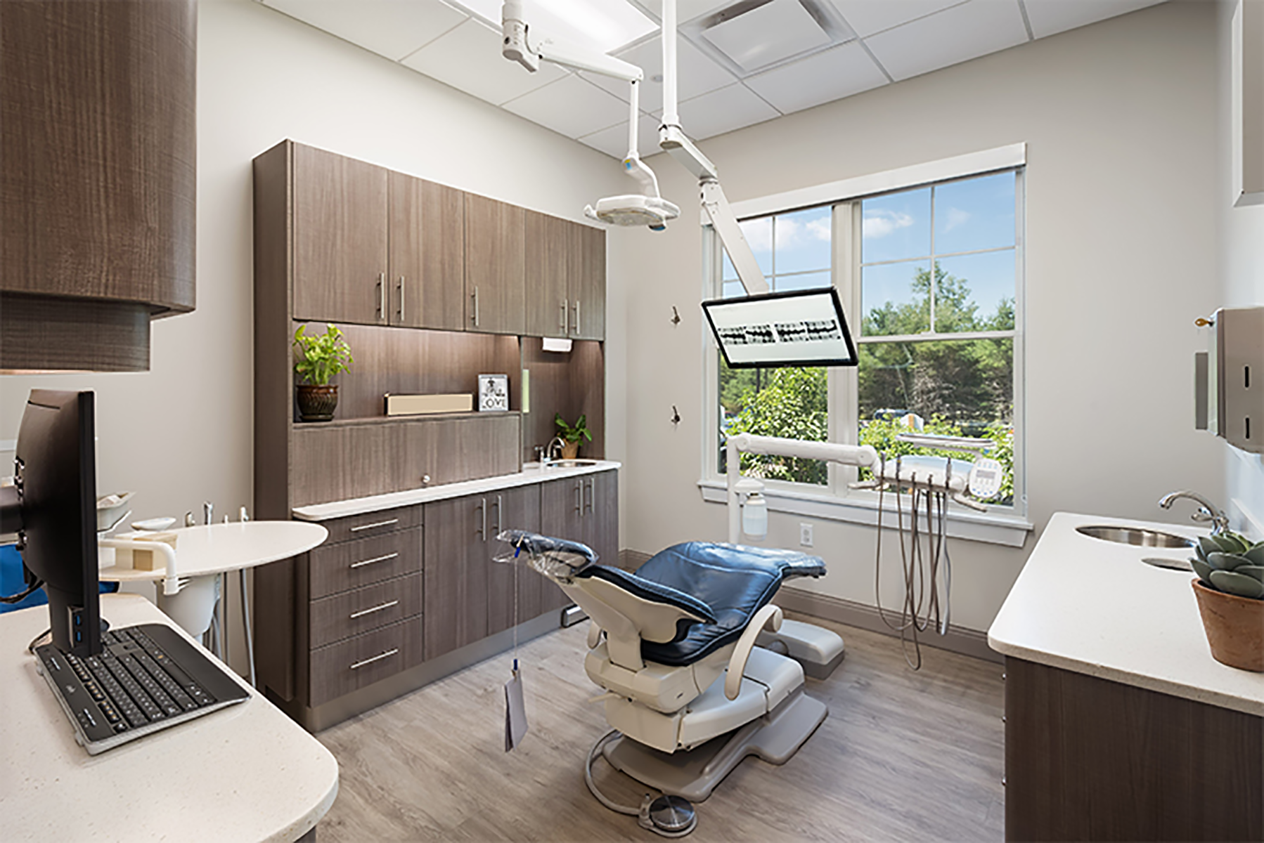 Single Elite Ceiling Monitor Mount Shown Inside Dental Office Operatory Station